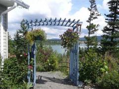 Blick durch einen Rankbogen bevor man von der sdwestlichen Giebelseite den im letzten Bild gezeigten Weg heruntergeht.